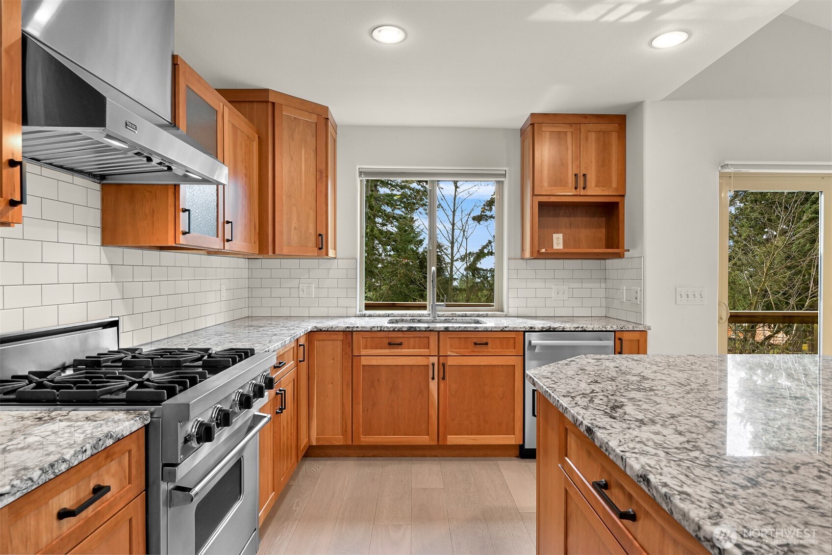 4135 Agate Road Bellingham, WA 98226 - Photo 10 of 36 a kitchen with stainless steel appliances granite countertop a stove a sink and a microwave