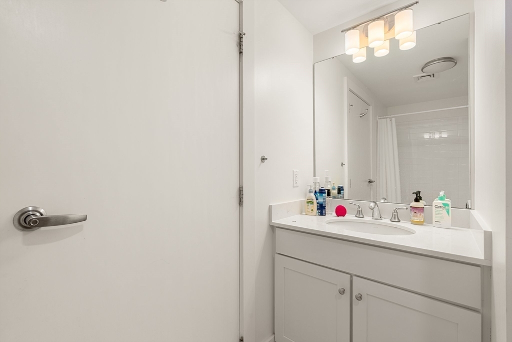 20 Penniman Road, Unit P3 Boston, MA 02134 - Photo 12 of 22 a bathroom with a sink and a mirror