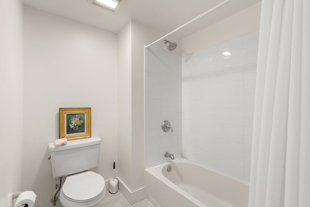 20 Penniman Road, Unit P3 Boston, MA 02134 - Photo 13 of 22 a white toilet sitting next to a bath tub
