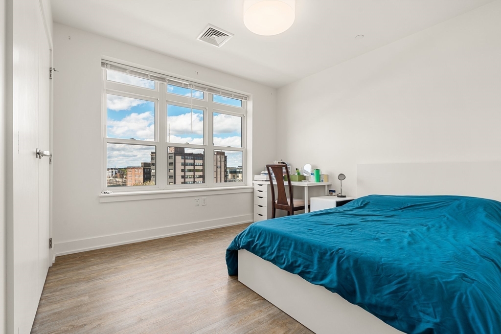 20 Penniman Road, Unit P3 Boston, MA 02134 - Photo 15 of 22 a spacious bedroom with a bed and a large window