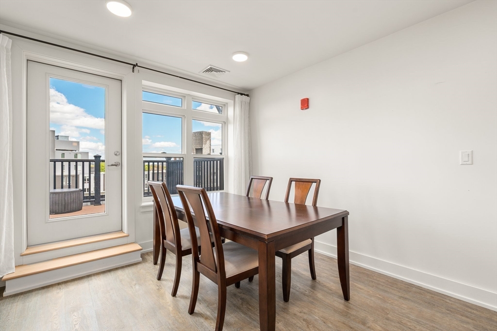 20 Penniman Road, Unit P3 Boston, MA 02134 - Photo 6 of 22 a view of a dining room with furniture window and wooden floor