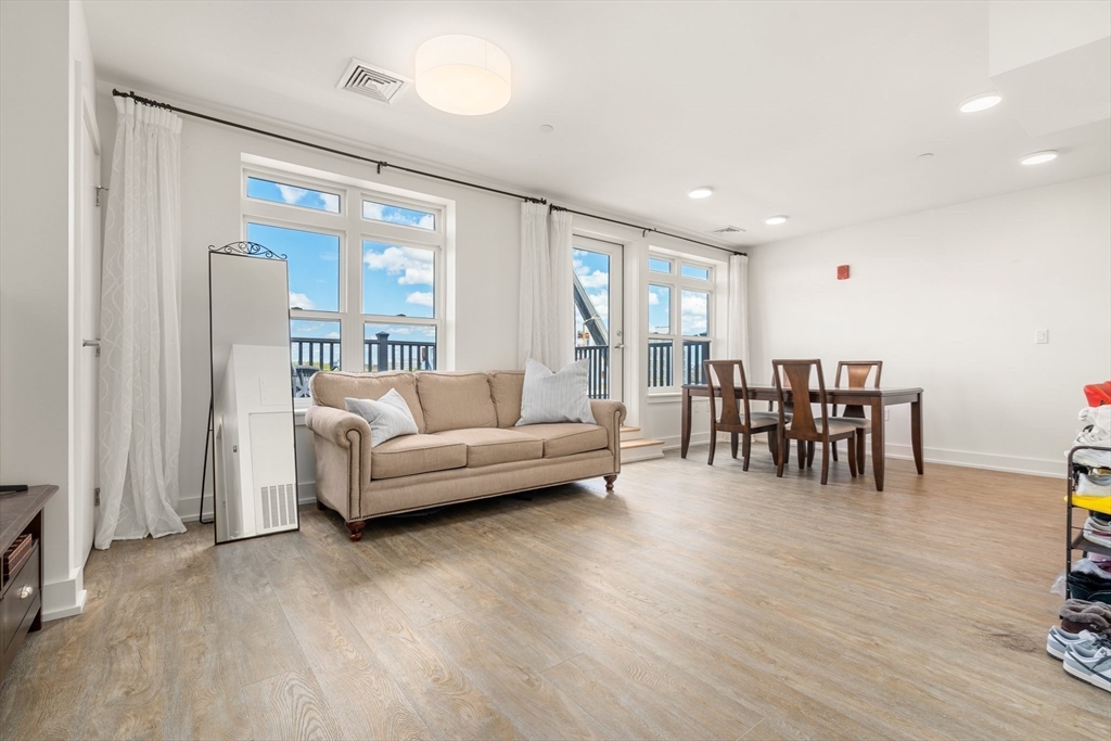 20 Penniman Road, Unit P3 Boston, MA 02134 - Photo 8 of 22 a living room with furniture and a wooden floor