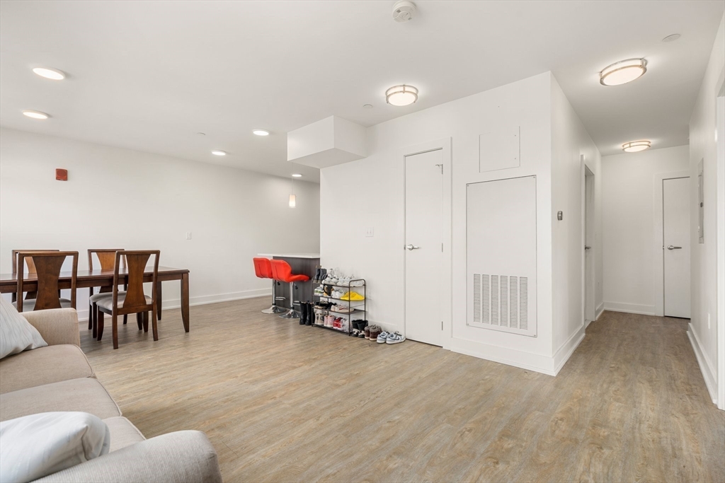 20 Penniman Road, Unit P3 Boston, MA 02134 - Photo 9 of 22 a living room with furniture and a wooden floor