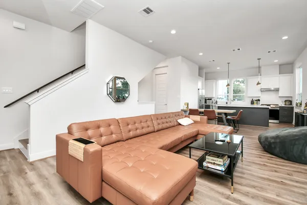 a living room with furniture and kitchen view