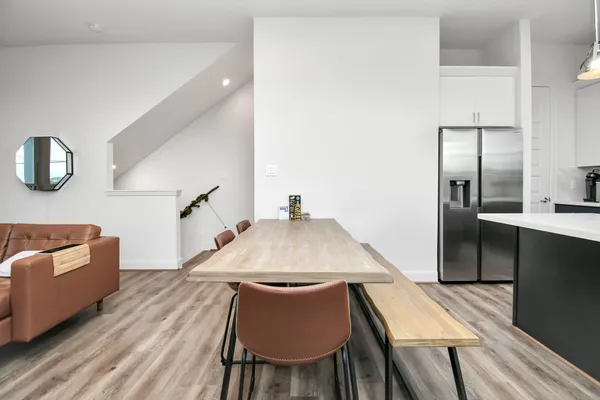 a dining room with furniture and wooden floor