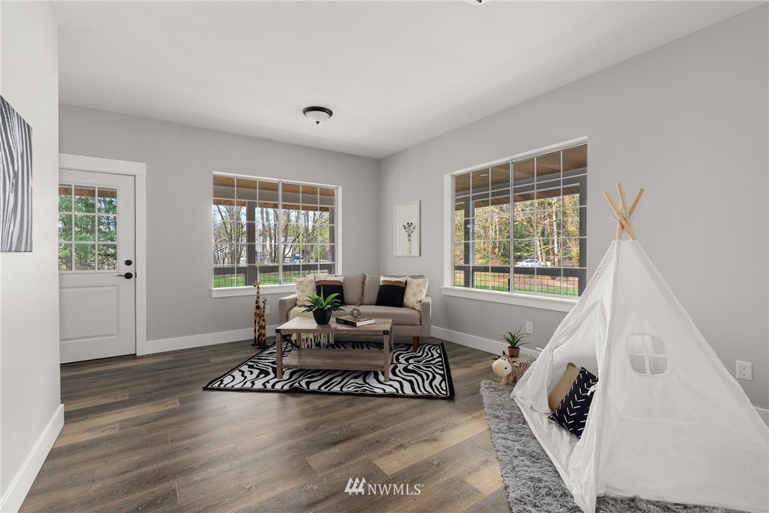 14126 Littlerock Road Southwest Rochester, WA 98579 - Photo 12 of 40 a living room with furniture and a large window