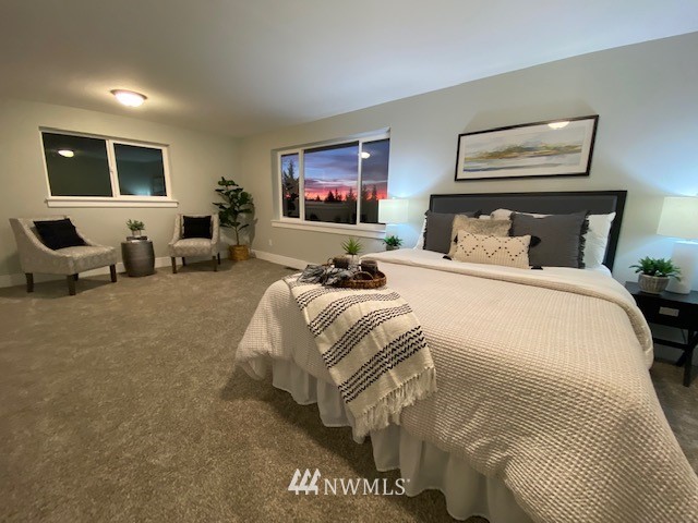 14126 Littlerock Road Southwest Rochester, WA 98579 - Photo 29 of 40 a spacious bedroom with a bed and glass window