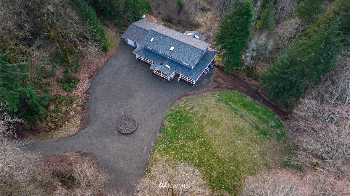 14126 Littlerock Road Southwest Rochester, WA 98579 - Photo 37 of 40 an aerial view of a house with garden space and trees all around
