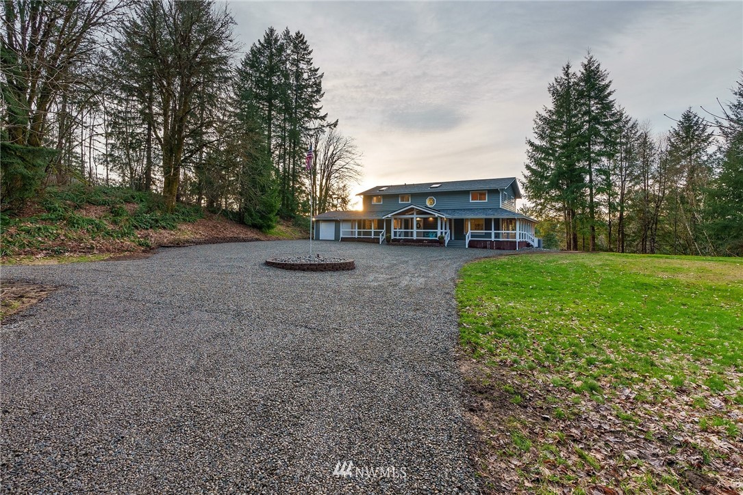 14126 Littlerock Road Southwest Rochester, WA 98579 - Photo 4 of 40 a view of a yard with a house in the background