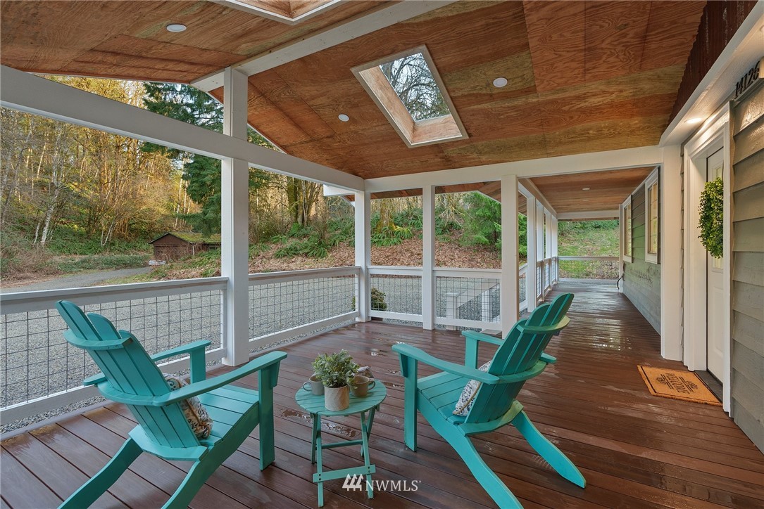 14126 Littlerock Road Southwest Rochester, WA 98579 - Photo 6 of 40 a porch with a table chairs and a potted plant