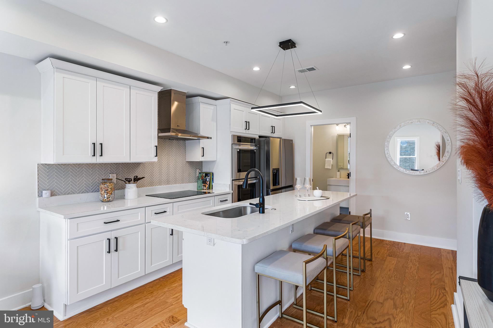 a kitchen with a sink cabinets and wooden floor