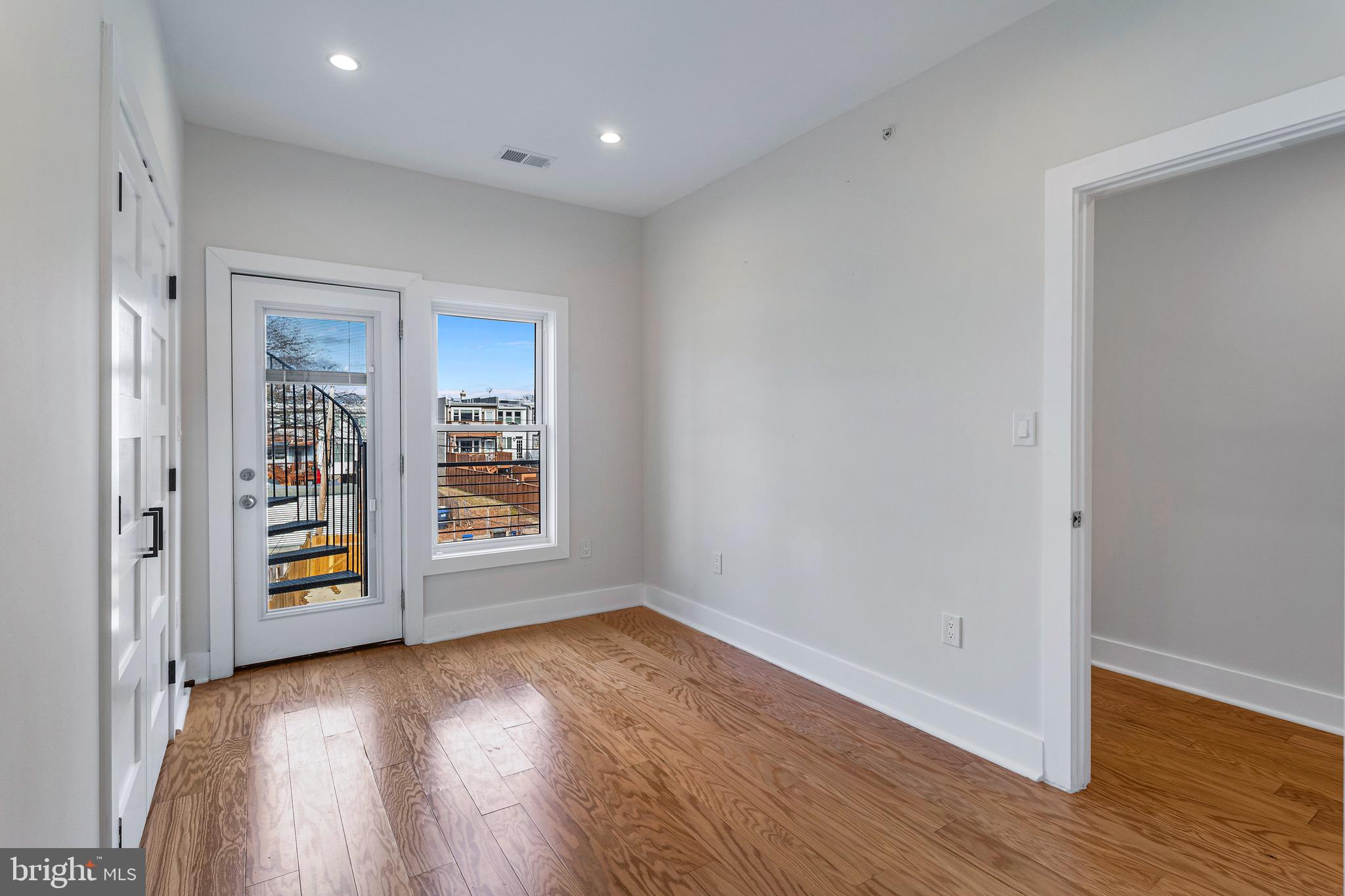 1118 Neal Street Northeast, Unit 2 Washington, DC 20002 - Photo 17 of 25 wooden floor in an empty room with a window