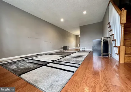 a bedroom with a bed and a wooden floor