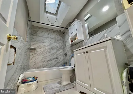 a bathroom with a toilet and a shower