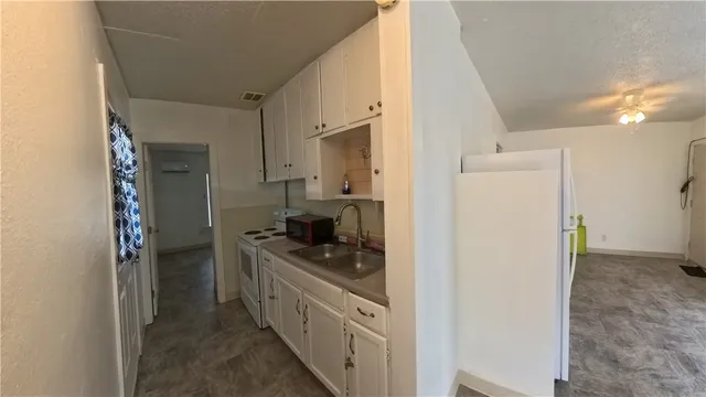 a kitchen with stainless steel appliances granite countertop a refrigerator and a stove