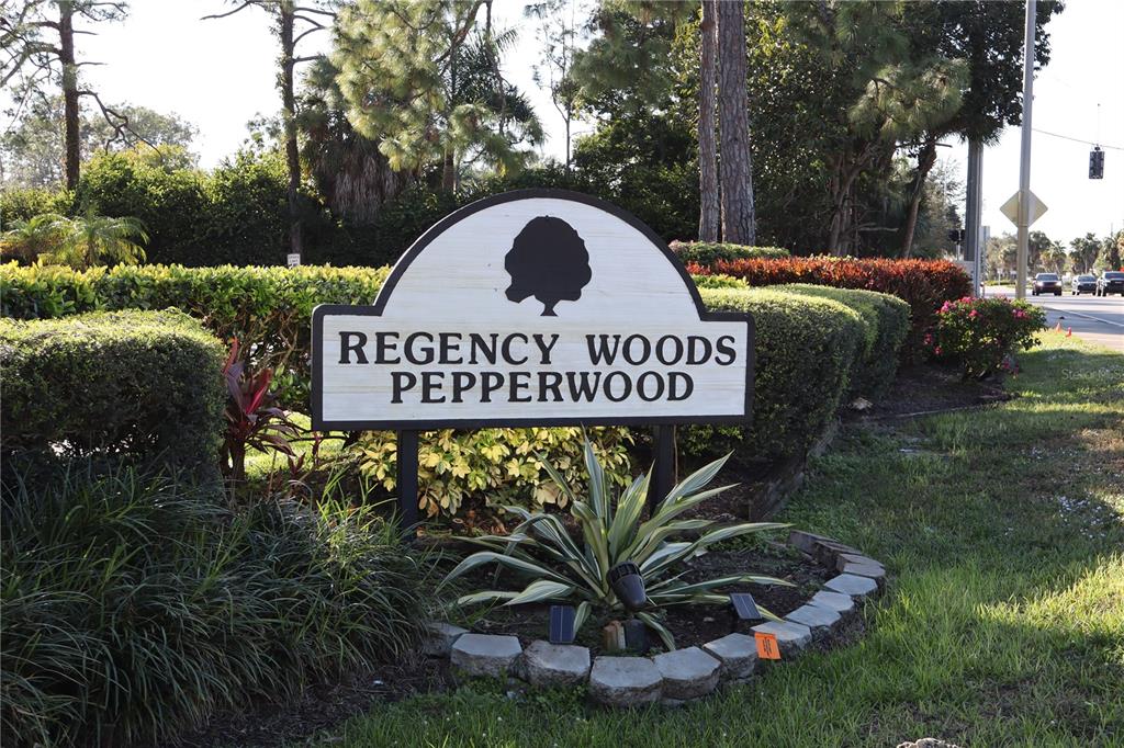 a view of a sign in a yard with green space