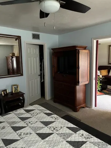 a bedroom with a bed a table and chair