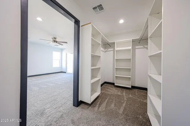 a view of an empty room and a bathroom