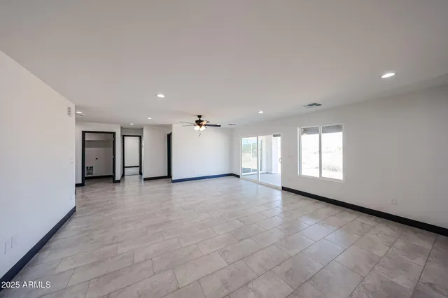 an empty room with windows and pillars in it