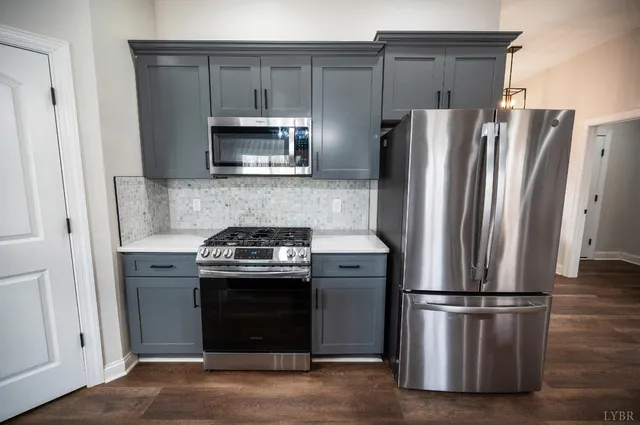 a stove top oven sitting inside of a kitchen