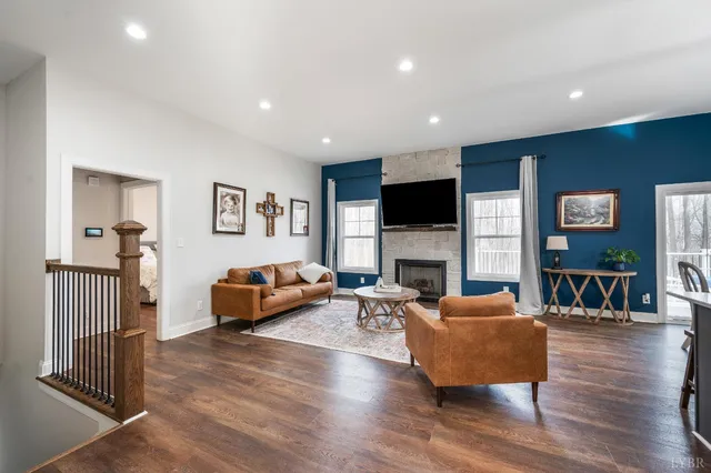 a living room with fireplace furniture and a flat screen tv