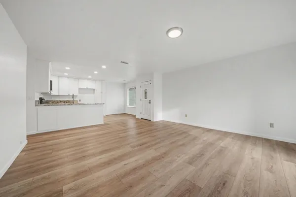 a bathroom with a granite countertop sink a toilet and shower