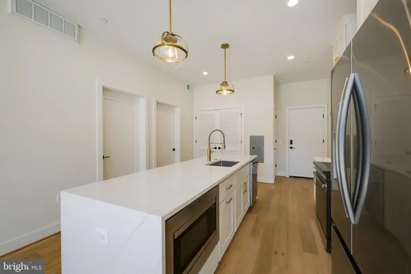 a kitchen with a sink and a refrigerator