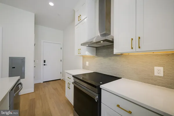 an empty room with wooden floor and glass door