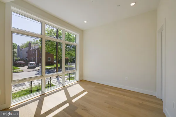 a bathroom with a bathtub shower sink vanity mirror and toilet