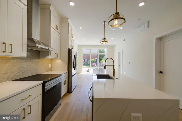 a kitchen with stainless steel appliances a refrigerator sink and microwave