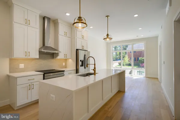 a kitchen with stainless steel appliances a refrigerator and a refrigerator