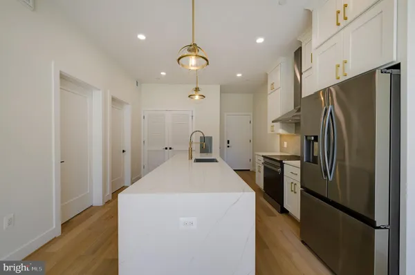 a kitchen with stainless steel appliances a stove and a refrigerator