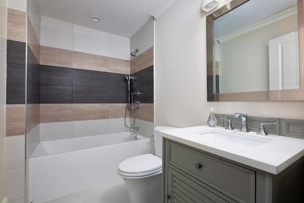 27 Summit Avenue, Unit 27 Brookline, MA 02446 - Photo 15 of 21 a bathroom with a sink toilet vanity and bathtub