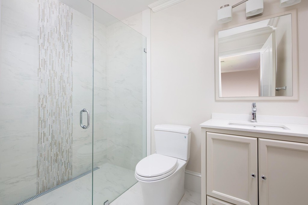 27 Summit Avenue, Unit 27 Brookline, MA 02446 - Photo 16 of 21 a bathroom with a toilet sink vanity and shower