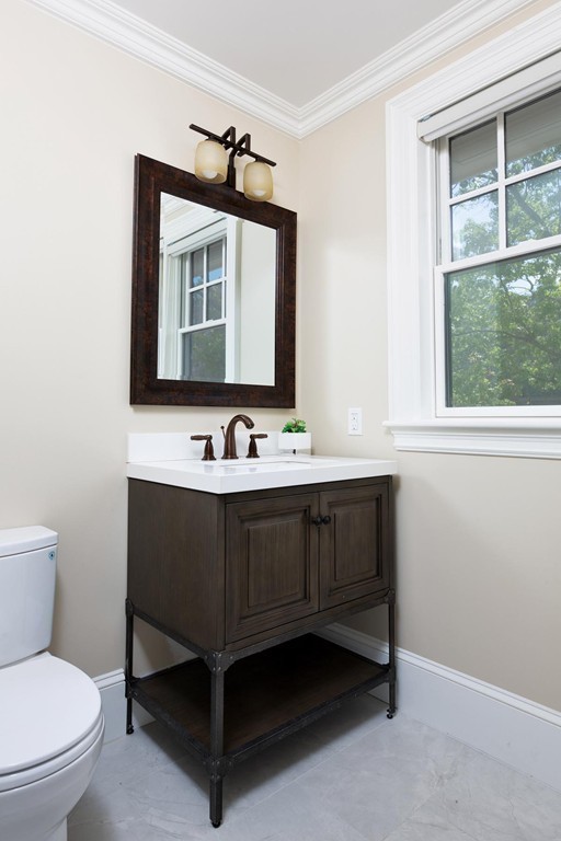 27 Summit Avenue, Unit 27 Brookline, MA 02446 - Photo 17 of 21 a bathroom with a toilet a sink and mirror