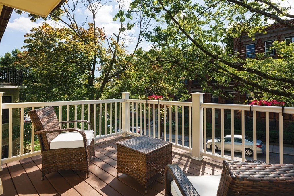 27 Summit Avenue, Unit 27 Brookline, MA 02446 - Photo 19 of 21 a balcony with wooden floor outdoor seating and yard in the back