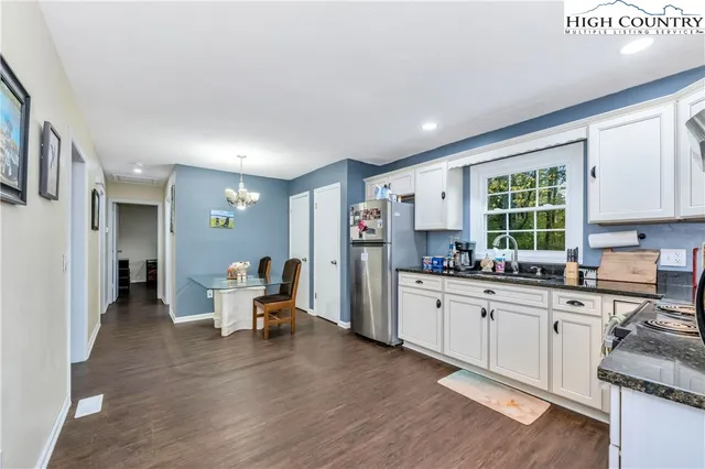 a view of a livingroom with wooden floor and a bookshelf
