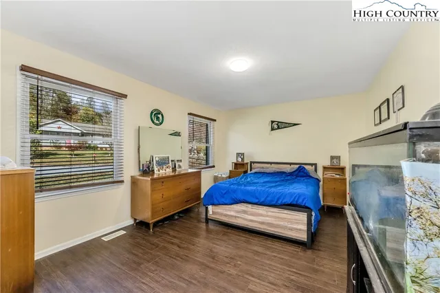 a bed room with a bed and a television