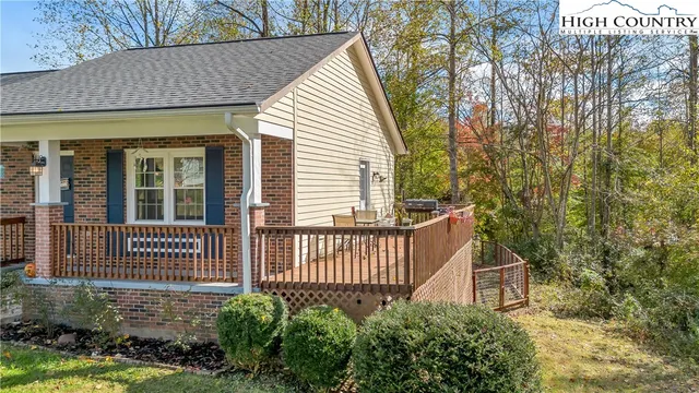 a view of a house with a small yard and wooden fence