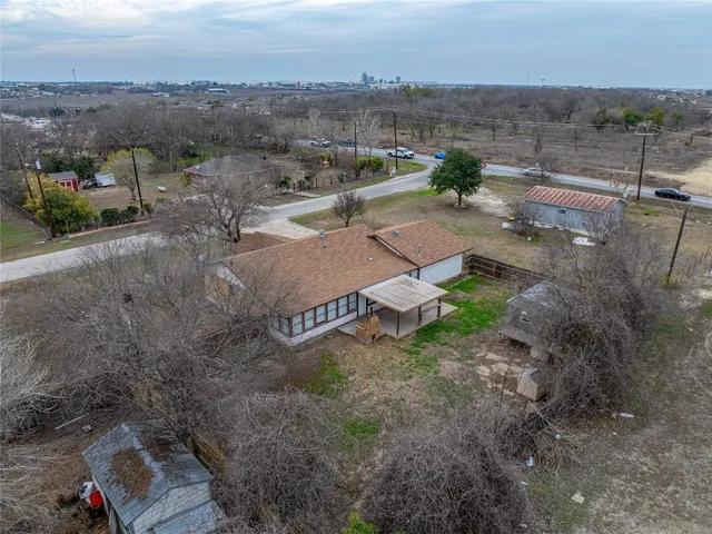 an aerial view of a house with a yard