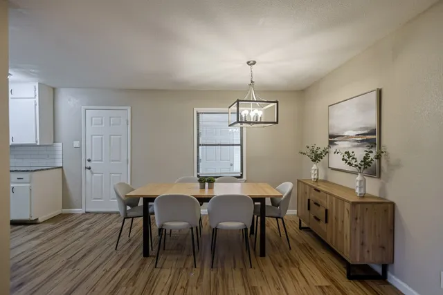 a view of a dining room with furniture and wooden floor