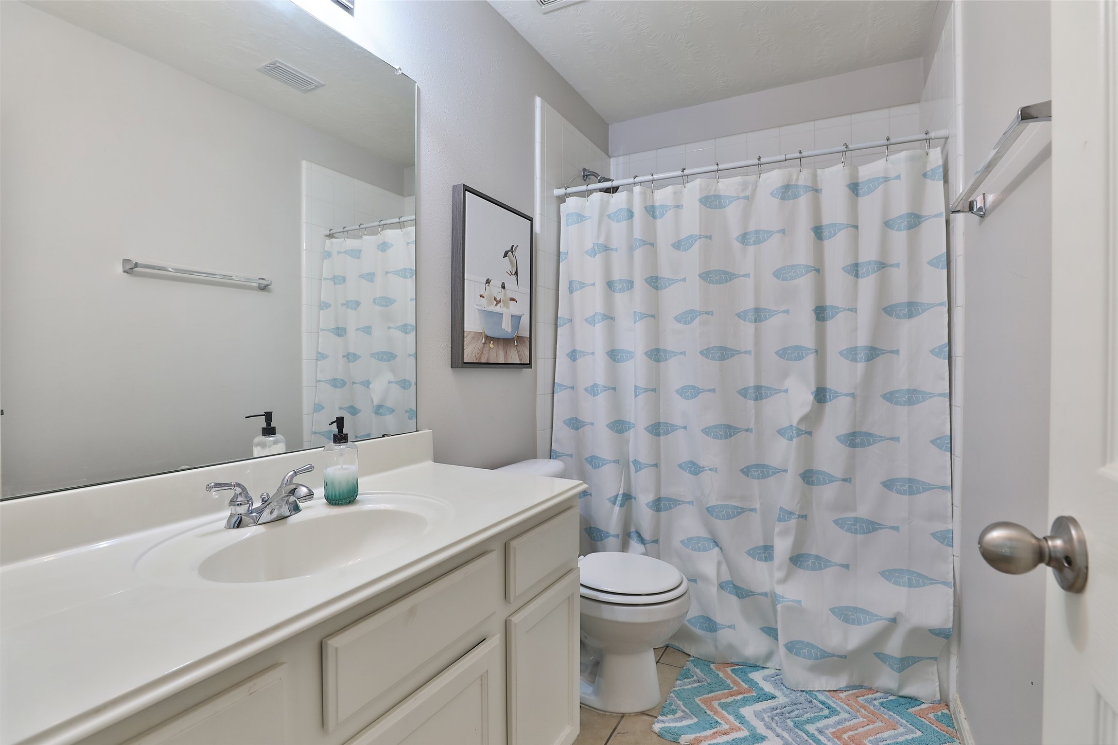 10514 Spice Ridge Row Missouri City, TX 77459 - Photo 30 of 43 a bathroom with a sink a toilet and shower curtain