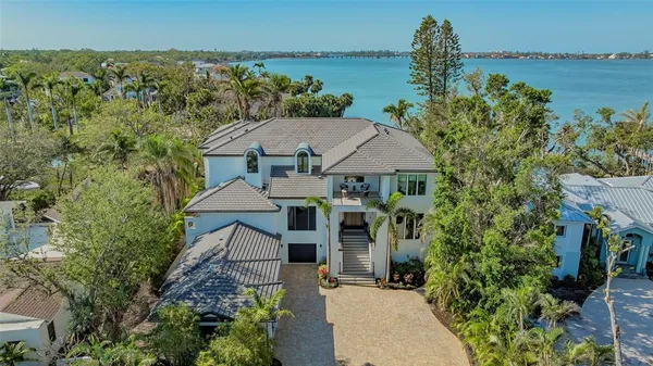 an aerial view of a house with a garden and trees