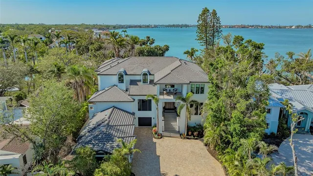 an aerial view of a house with a garden and trees