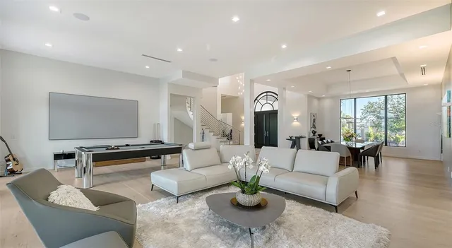 a living room with furniture and large windows