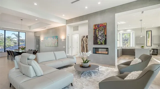 a living room with furniture and large windows