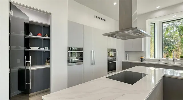 a bedroom with furniture and large windows