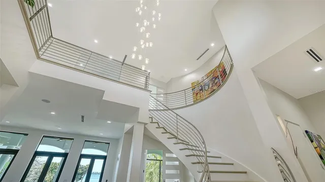 a living room with furniture and large windows