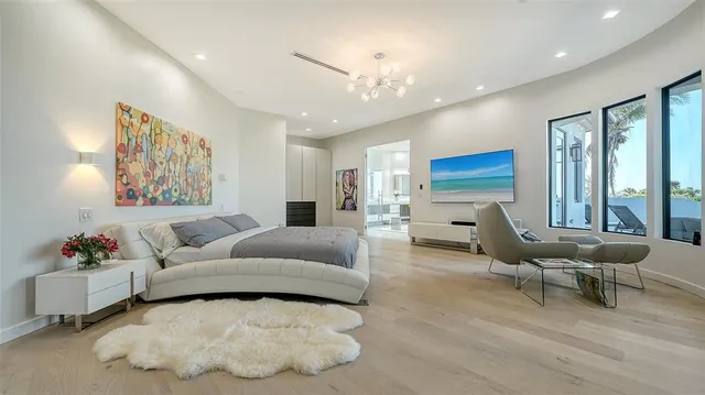 a living room with furniture and large windows