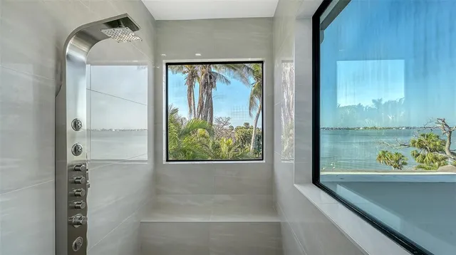a view of a swimming pool with a table and chairs under an umbrella